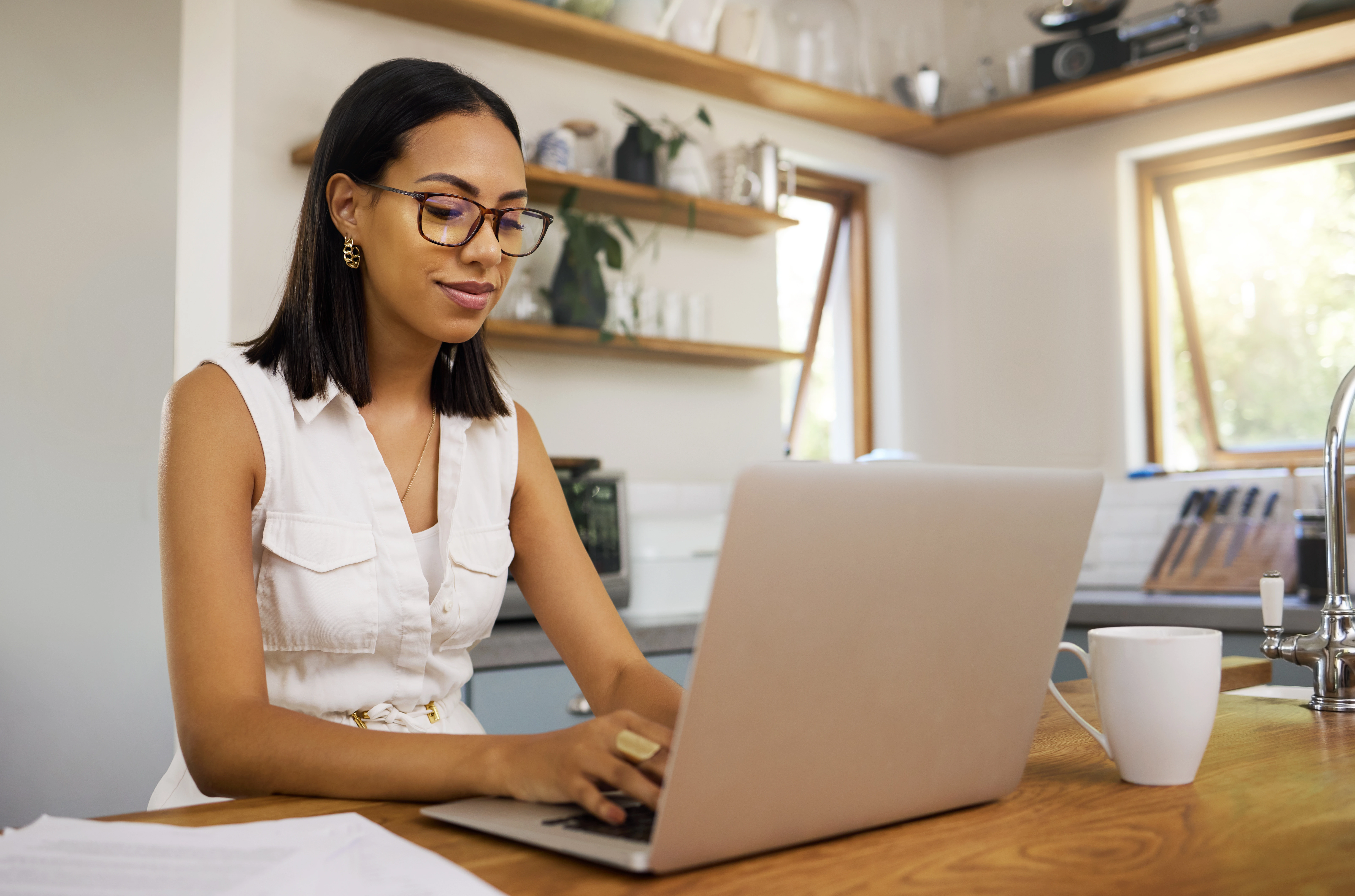 Professional woman working remotely on a laptop in her home office